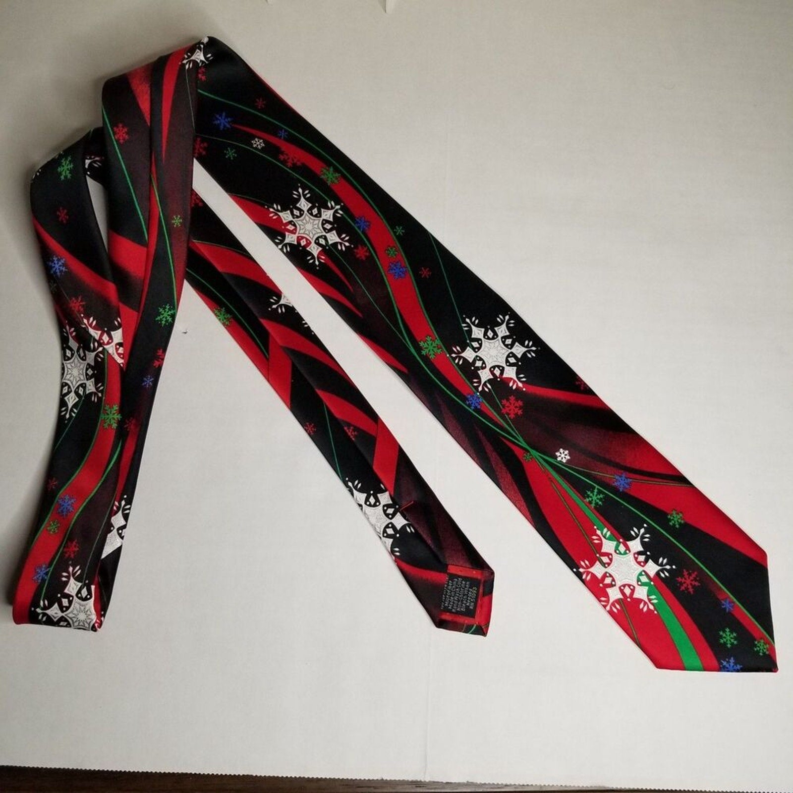 Multicolor Snowflakes on Red Black Wavy Background Neck Tie Christmas Holiday