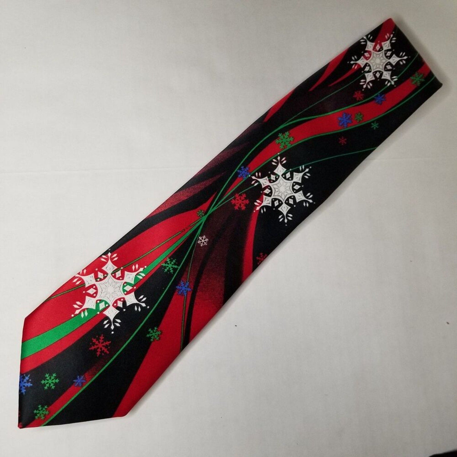 Multicolor Snowflakes on Red Black Wavy Background Neck Tie Christmas Holiday